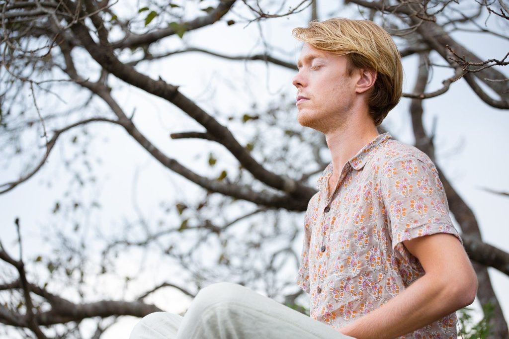 Man meditating not reacting but responding